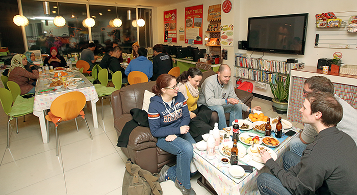 Travelers gather in the kitchen of the Yeha Guesthouse, sharing their stories with each other.