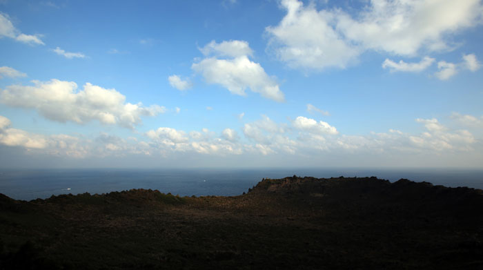 The Seongsan <i>Ilchulbong</i> got its name as the mountain is shaped like a castle, surrounded by about 100 rocks, and from it can be seen a great sunrise. 